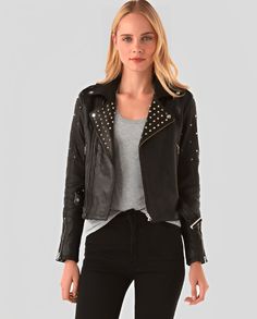 Women's Studded Biker Leather Jacket In Black Rock Style Studded Leather Jacket For Winter, Winter Rock Style Leather Jacket With Studs, Edgy Studded Long Sleeve Biker Jacket, Edgy Studded Biker Jacket, Rocker Leather Jacket With Studs, Rocker Style Studded Leather Jacket For Biker Events, Rocker Leather Jacket With Studs For Biker Events, Edgy Studded Biker Jacket For Winter, Punk Leather Jacket With Rhinestone Rivets For Fall