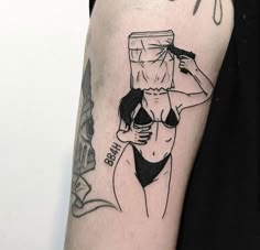 a woman with a bucket on her head is depicted in this black and white tattoo