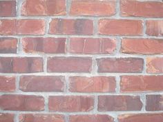 a red brick wall is shown in close up