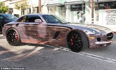 a metallic sports car parked on the street