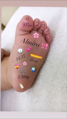 a baby's feet with the birth date written on it