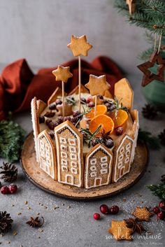 a decorated christmas cake with orange slices and stars on top, surrounded by other decorations