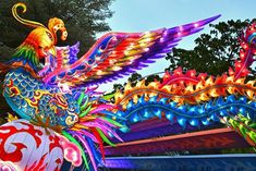 an elaborately decorated dragon float in front of trees