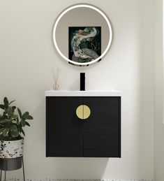 a bathroom with a round mirror on the wall and a black cabinet in front of it