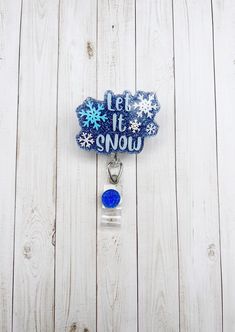 "Let It Snow Badge Reel Decorated with a beautiful blue glitter, glitter and details sealed with resin for a smooth, long lasting finish and shine! Measures approximately 2\" wide by 1.6\" tall. This is made to hold ID badges, choose from an alligator swivel clip, belt clip, MRI safe badge clip, or lanyard - see listing photos for examples of each! ⭐️ Alligator Swivel Clip ⭐️  Most popular option! The swivel spring clip on the back of the reel provides a 360-degree rotation in any direction. 34\ Stephanie Brown, Nurse Badge Holders, Id Badge Holders, Let It Snow, Blue Glitter, Id Badge, Badge Holders, Badge Holders Lanyard, Nurse Gifts