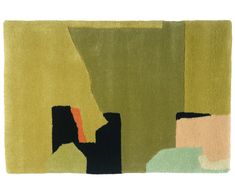 a green rug with black, yellow and orange shapes on the bottom right hand side