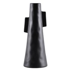 a black vase sitting on top of a white table