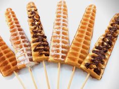 five waffles with chocolate on them are lined up in the shape of corn cobs