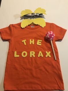 the lorax t - shirt with sunglasses on it and candy in his mouth