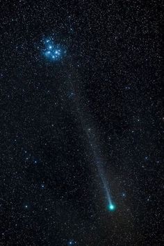 the comet is shining brightly in the night sky