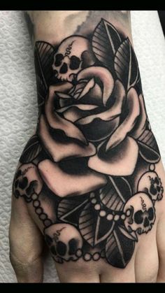 a black and white rose with skulls on it's left hand is featured in this image