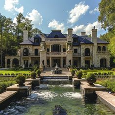 a large house with a fountain in front of it