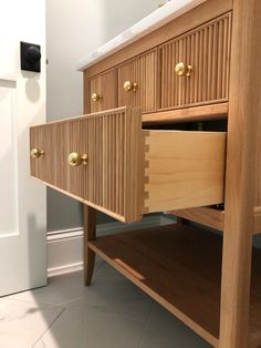 a close up of a wooden cabinet with drawers