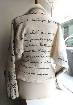 a mannequin wearing a jacket with writing on it