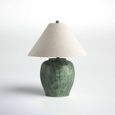 a green table lamp with a white shade on the base and a beige linen lampshade