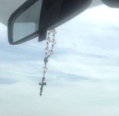 the rear view mirror of a car with a chain hanging from it's side