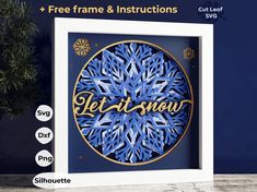 a blue snowflake with the words let it snow in gold lettering