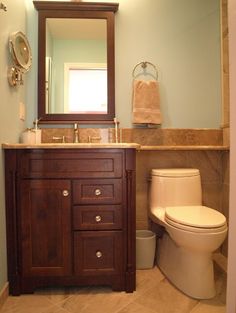 a bathroom with a sink, toilet and mirror