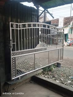 an iron gate in front of a building with broken glass on the ground and debris around it