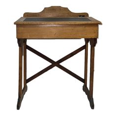 an old wooden desk with a tray on it's top and two legs at the bottom