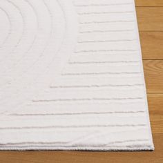 a white rug with wavy lines on the floor