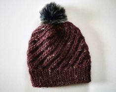 "Hand knitted, soft, and oh so cozy, this hat will keep you warm all winter long.  It will make the perfect gift for yourself or for a loved one. Made to fit an average women's head size of 21-23\" (53-58.5 cm). Color: Maroon Materials: 50% wool, 50% acrylic yarn Pattern: Alpine Swirl Hat by Jennifer Dougherty (@knitbyjennifer on Instagram)." Swirl Hat, Adjustable Purple Hand-knitted Hat, Winter Hat, Acrylic Yarn, Caps Hats, Hand Knitting, Swirl, Accessories Hats, Winter Hats