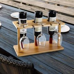 three bottles of wine sitting on top of a wooden table