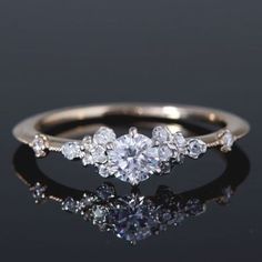 a three stone diamond ring on a reflective surface