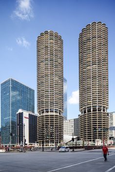 two tall buildings in the middle of a parking lot