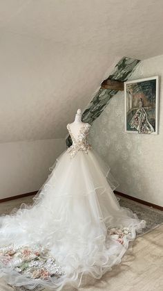 a wedding dress on display in an attic