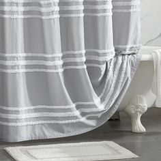 a white bath tub sitting next to a shower curtain