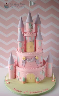 a pink princess castle cake on a table