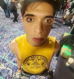 a man making a face while standing in front of a luggage bag on the floor