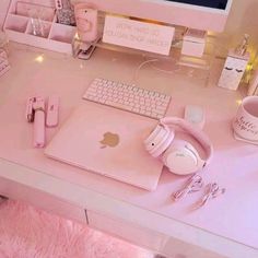 a desk with a keyboard, mouse and headphones on it in front of a computer monitor