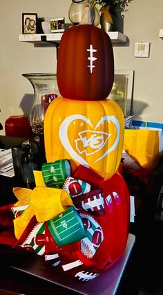 an inflatable football helmet is sitting on top of candy bags and other decorations