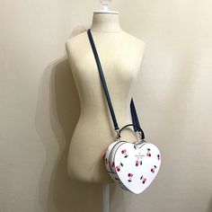 Kate Spade Crossbody Bag New With Tags Love Shack Heart Crossbody Bag Ivory Cream With Cherry Print Interior Has Slots For Cards Very Very Dark Blue - Almost Black - Detachable Strap Measures Approx 8" Across X 7" High X 2.25" Deep Smoke Free Pet Friendly Home Perfect For Gift Giving - Or Keeping For Yourself!! Check Out My Closet For More Bags And Other Fabulous Things - Bundle & Save! Packaged With Care & Shipped Fast Top Rated Seller & Posh Ambassador New To Poshmark?? Welcome! Sign Up Using Heart Crossbody Bag, Kate Spade Heart, Kate Spade Crossbody Bag, Designer Leather Bags, Black Leather Crossbody Bag, Cherry Print, Kate Spade Purse, Black Crossbody, Black Cross Body Bag