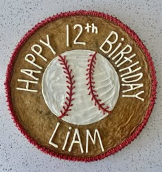 a birthday cake with a baseball on it and the words happy 12th birthday llam