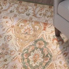 a living room with a couch and rug on the floor