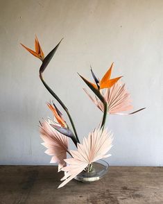 a vase filled with flowers on top of a wooden table