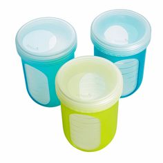 three plastic containers with lids on each side and one has a lid in the middle