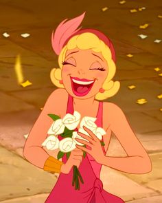 a woman in pink dress holding flowers and smiling