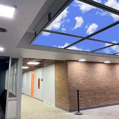 an empty room with sky and clouds painted on the ceiling