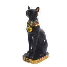 a black cat statue with gold and jewels on it's collar, sitting in front of a white background