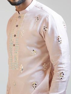 This Baby Pink Mirror Work kurta set will instantly give an elegant look. This 2 piece kurta set features a bam silk baby pink kurta, mirror work embroidery, front buttons fastening, and a mandarin collar. It is paired with narrow fitted pajama pants in cream color and malai cotton fabric. An ideal outfit for traditional occasions, and special events. Size Chart For Men Size Chart For Men Size Chart For Men Description Sizes run small Baby Pink Kurta For Men, Traditional Indian Mens Clothing, Embroidery Shirt Men, Mirror Work Kurta, Mirror Work Embroidery, Kids Indian Wear, Pink Kurti, Sherwani For Men Wedding, Boys Kurta Design