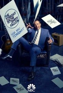 a man sitting on top of a chair holding a sign