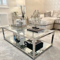 a living room with a glass coffee table