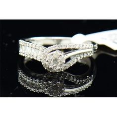 two wedding rings on top of each other, with diamonds in the middle and bottom