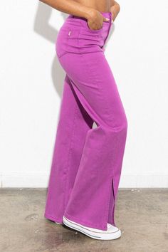 Step into a world of vibrant confidence with our Purple Wide Leg Pants With Slits. Imagine yourself gliding through the city, turning heads as the rich, royal purple hue catches the sunlight. These aren't just pants; they're a statement of your bold, free-spirited personality. The wide-leg silhouette paired with daring slits creates a mesmerizing flow as you walk, embodying both elegance and edge. Perfect for the fashion-forward woman who isn't afraid to stand out, these pants effortlessly trans