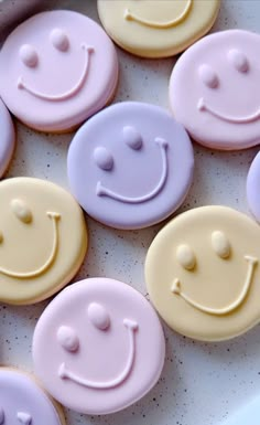 there are many decorated cookies in the shape of smiley faces