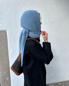 a woman with a blue scarf on her head